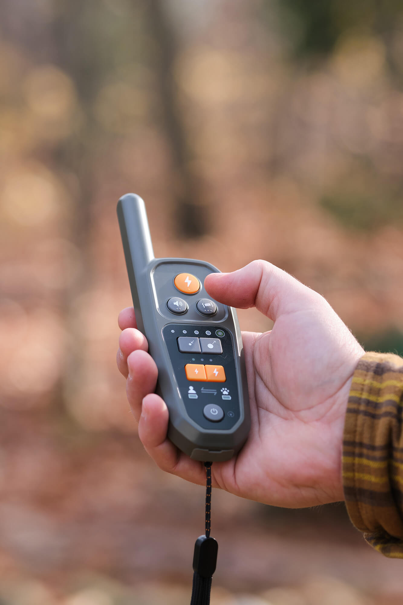 Hand holding a Heel Virtual Dog Leash™ Roam 350™ Remote